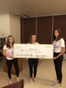 Three students holding giant YPI cheque