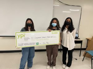 three students holding giant YPI cheque