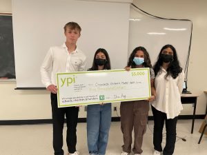 4 students holding YPI cheque